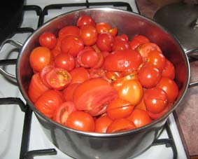 photo of chopped tomatoes in a pot.