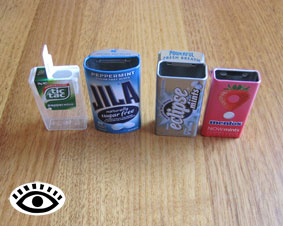 Photo of four mint boxes with their flip top lids open.