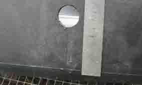 Photo of plastic tub with 20  mm hole drilled in it.