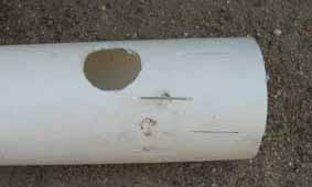 Photo of PVC pipe with 20 mm hole drilled into it.