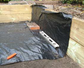 Photo of woven weed matting being laid out.