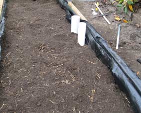 Photo of a wicking bed with soil added to it.