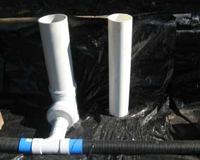 Photo of the inlet and outlet pipes in a wicking bed.